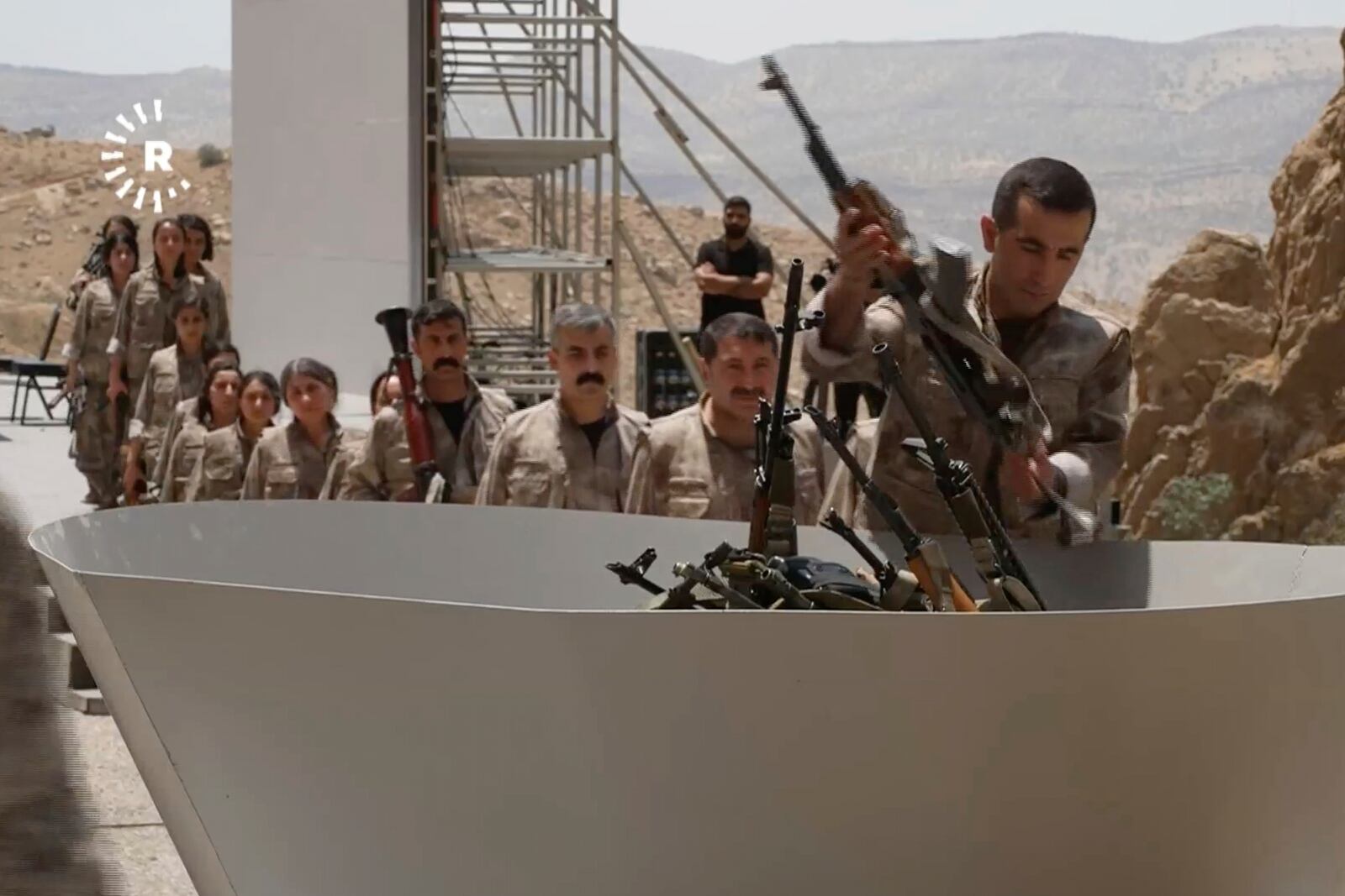 This frame grab from a video released by Rudy TV shows PPK (Kurdistan Workers' Party) fighters during a symbolic disarmament ceremony as part of the peace process with Turkey, in Sulaymaniyah governorate, in Iraq's semi-autonomous Kurdish region, Friday, July 11, 2025. (Rudaw TV via AP)