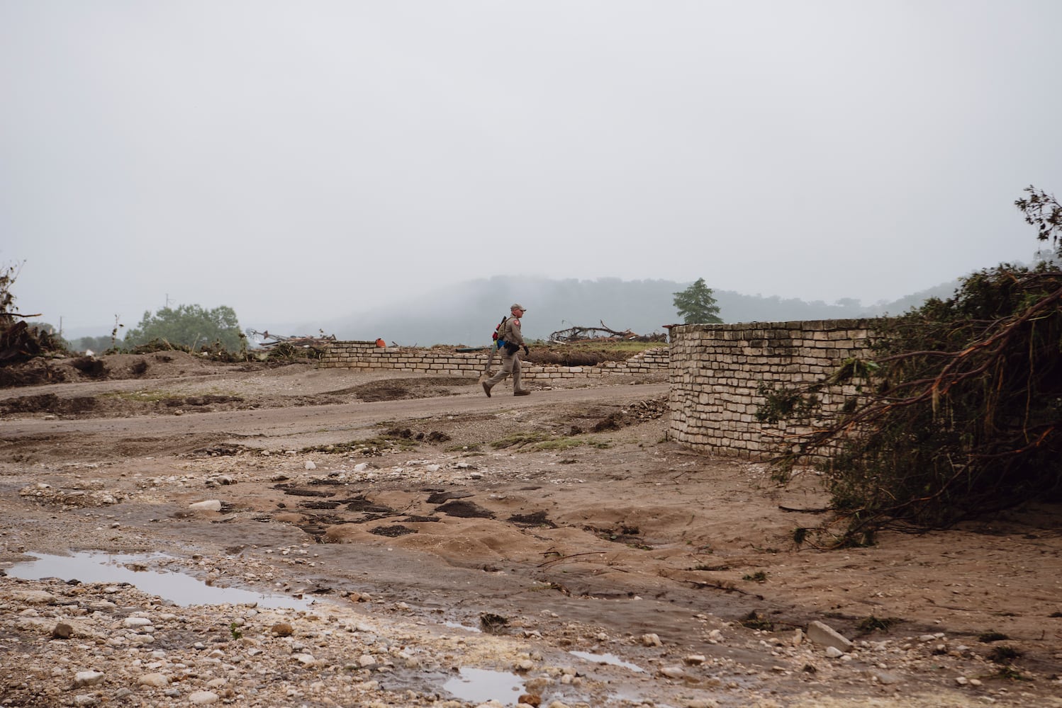 Rescuers search the grounds for missing people near  Camp Mystic in Hunt, Texas, on Saturday, July 5, 2025. (Carter Johnston/The New York Times)