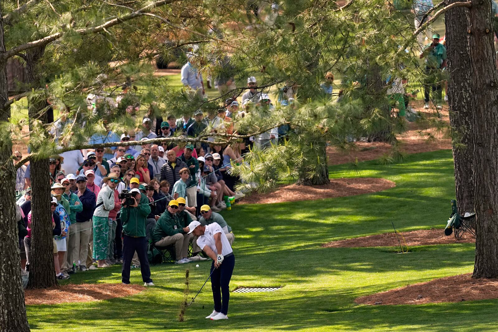 Bryson DeChambeau hits from the rough on the seventh hole during the third round at the Masters golf tournament, Saturday, April 12, 2025, in Augusta, Ga. (AP Photo/David J. Phillip)