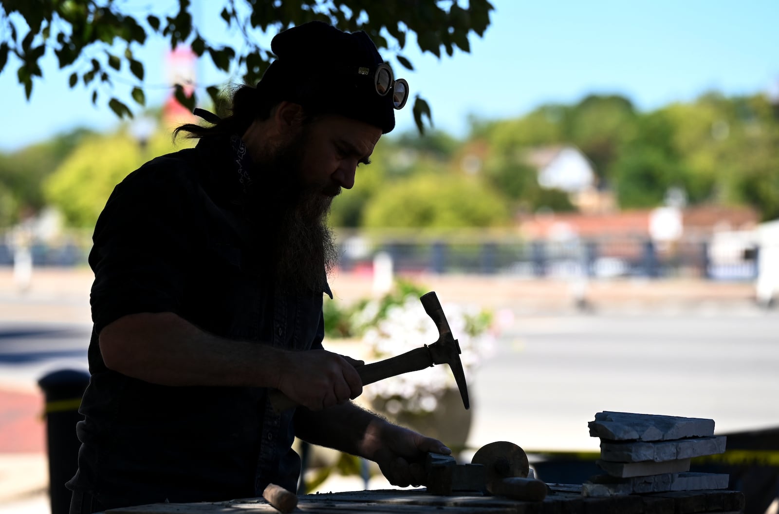 Devin Devine is a sculptor charged with creating a piece of art outside of the Well House Hotel in downtown Hamilton. It's the first piece commissioned by the City of Sculpture in a couple of years. Pictured is Devine working on the art installation on Oct. 9, 2025. MICHAEL D. PITMAN/STAFF