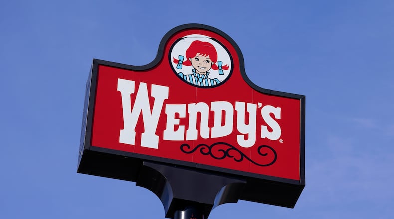 FILE - A sign stands over a Wendy's restaurant, Feb. 25, 2021, in Des Moines, Iowa. (AP Photo/Charlie Neibergall, File)
