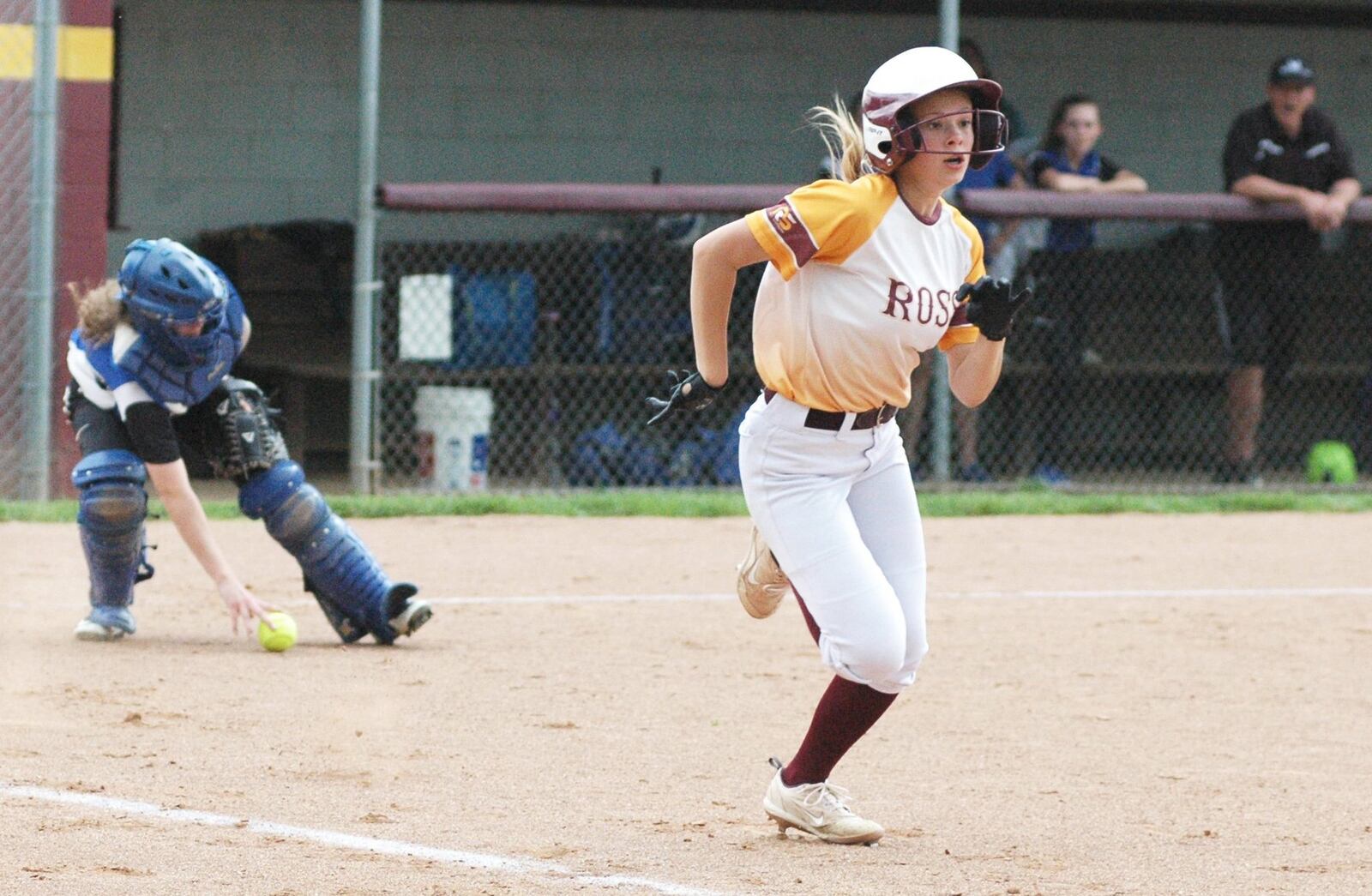 Madison Minges of Ross sprints toward first base as Wyoming catcher Emma Galinger picks up the ball Tuesday during a Division II sectional softball game in Ross Township. Ross won 17-4 in five innings. RICK CASSANO/STAFF