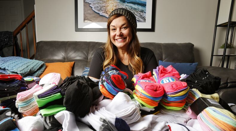 Monique Runzer is collecting socks for her Socks for Hamilton Youth program. This is her third year and is on her way to collecting 2000 pairs of socks to give to local youth in need. NICK GRAHAM / STAFF