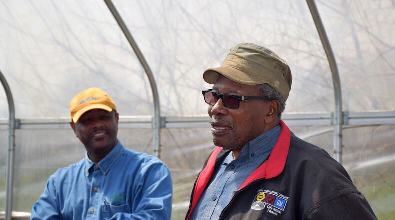 Standing in his high tunnel and garden with NRCS urban conservationist Al Norwood (left), Avon Standard (right) was the first to apply under the Cleveland High Tunnel Initiative. Both are speakers for the virtual Black Farming: Beyond 40 Acres and a Mule virtual conference Sept. 11-12. CONTRIBUTED