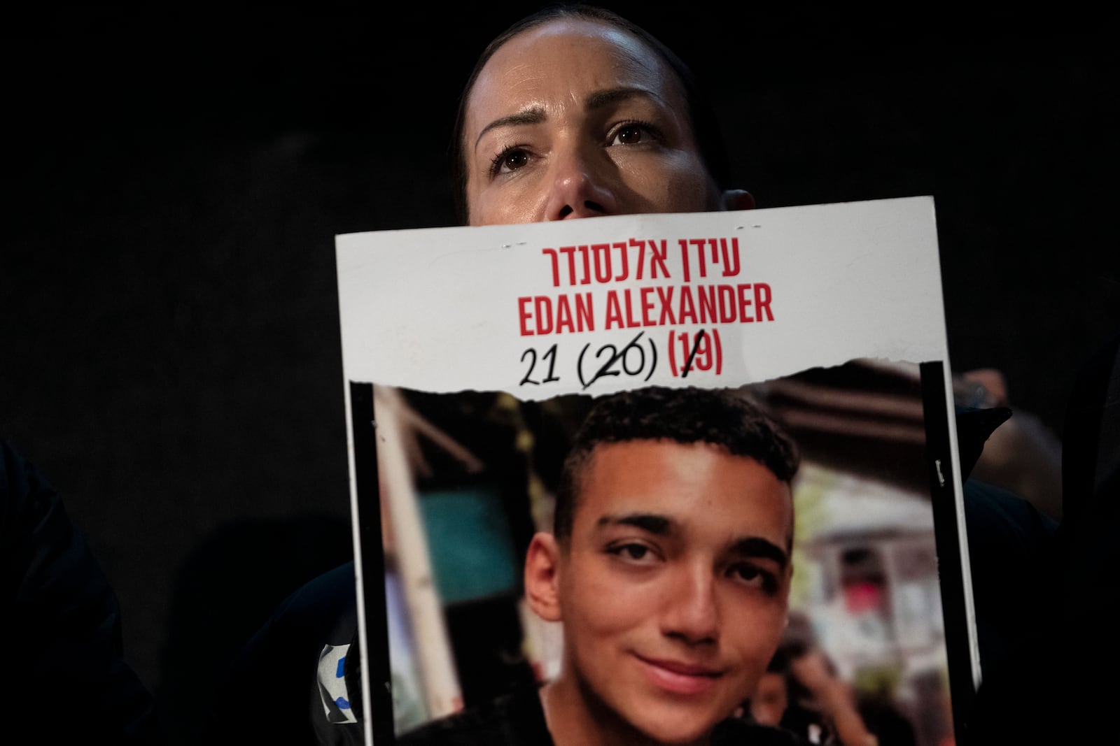 FILE - Yael Alexander holds a poster of her son, Edan, who was taken hostage by Hamas militants on Oct. 7, 2023, during a weekly rally for families of hostages held in the Gaza Strip and their supporters, in Tel Aviv, Israel, Feb. 22, 2025. (AP Photo/Maya Alleruzzo, File)