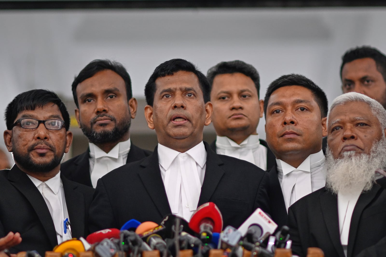 Chief Prosecutor Mohammad Tajul Islam, center, speaks to the media after a special tribunal indicted Bangladesh’s ousted Prime Minister Sheikh Hasina by accepting charges of crimes against humanity filed against her at the International Crimes Tribunal in Dhaka, Bangladesh, Thursday, July 10, 2025. (AP Photo/Mahmud Hossain Opu)