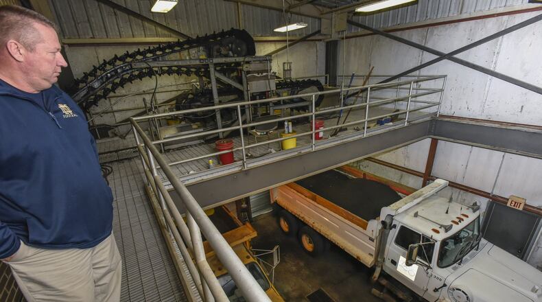 Mark Smith, biosolids manager at Butler County Water and Sewer Department, shows part of the process at their Liberty Twp. facility just before the materials are trucked away to another facility for processing. Butler County’s Water and Sewer Department is examining cost-saving opportunities for a regional biosolids processing reuse facility and has asked other local municipalities to be involved. NICK GRAHAM/STAFF