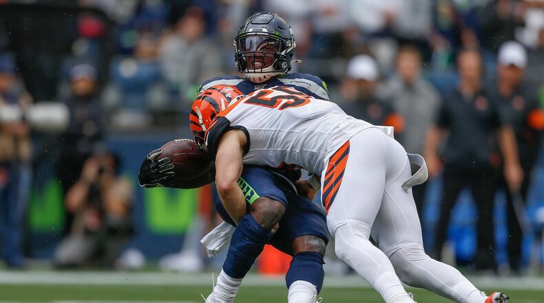 SEATTLE, WA - SEPTEMBER 08: Running back Chris Carson #32 of the Seattle Seahawks is tackled by linebacker Nick Vigil #59 of the Cincinnati Bengals at CenturyLink Field on September 8, 2019 in Seattle, Washington. (Photo by Otto Greule Jr/Getty Images)