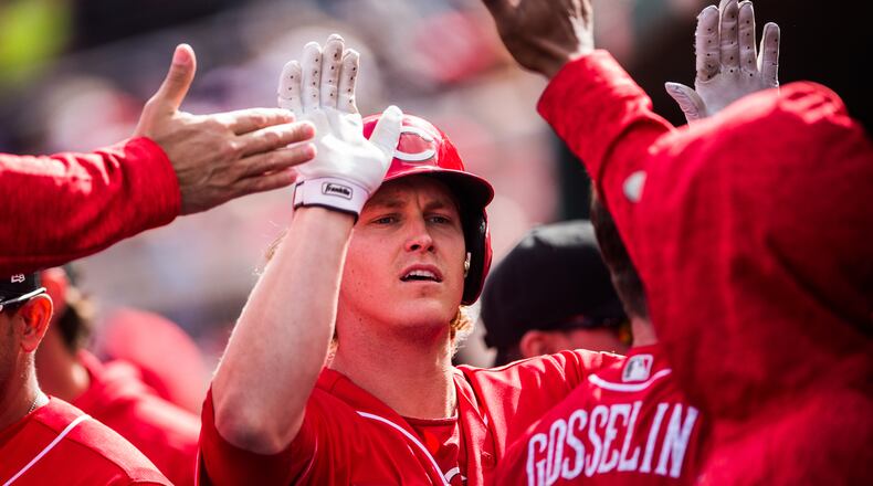 The Reds’ Brandon Dixon greets his teammates in the dugout after hitting a 2-run home run against the Cleveland Indians during spring training on February 23, 2018 in Goodyear, Arizona. (Photo by Rob Tringali/Getty Images)