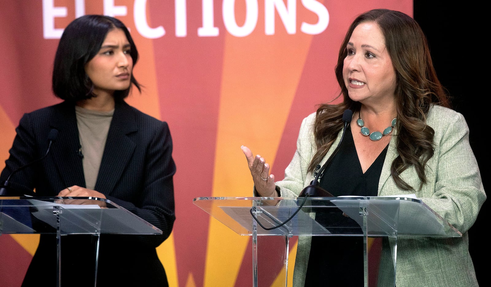 Deja Foxx, left, looks over at Adelita Grijalva as she answers a question during the Democratic primary debate inside the Arizona Public Media studio in Tucson, Ariz., June 10, 2025. (Mamta Popat/Arizona Daily Star via AP)