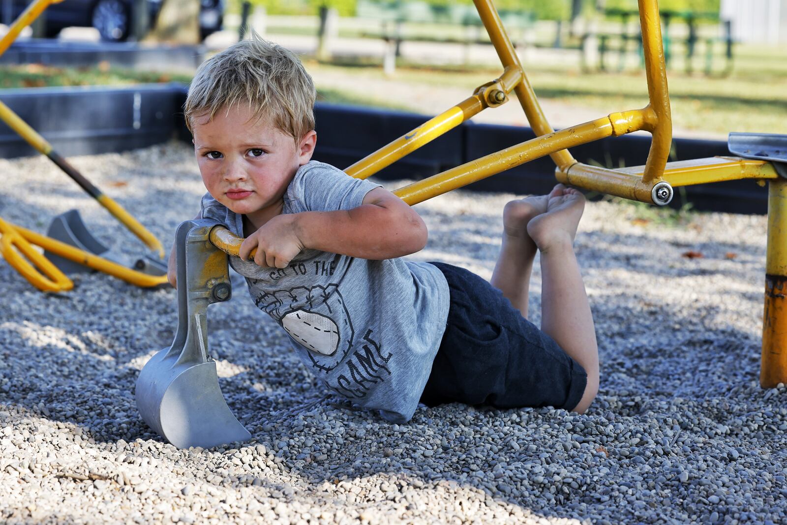 Drew Puckett, 3, plays at a park Thursday, Aug. 26, 2021 in Hanover Township. Puckett was treated by Shriner's Children's Ohio for severe burns to his feet last year after he walked through hot coals that remained after a campfire. NICK GRAHAM / STAFF