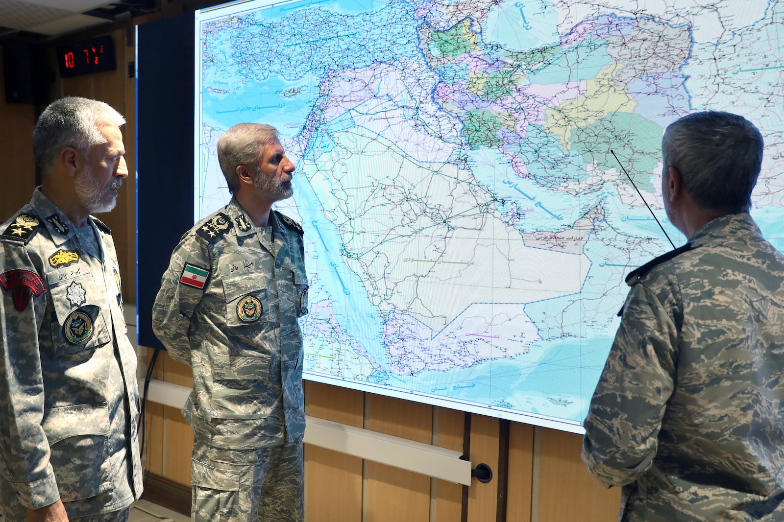 In this photo released on Monday, 23, 2025, by Iranian army press service, Iran's army commander-in-chief Gen. Amir Hatami, center, Admiral Mahmoud Mousavi, right, and Admiral Habibollah Sayyari attend a meeting in Zolfaghar central headquarters, Iran. (Iranian Army Press Service via AP)