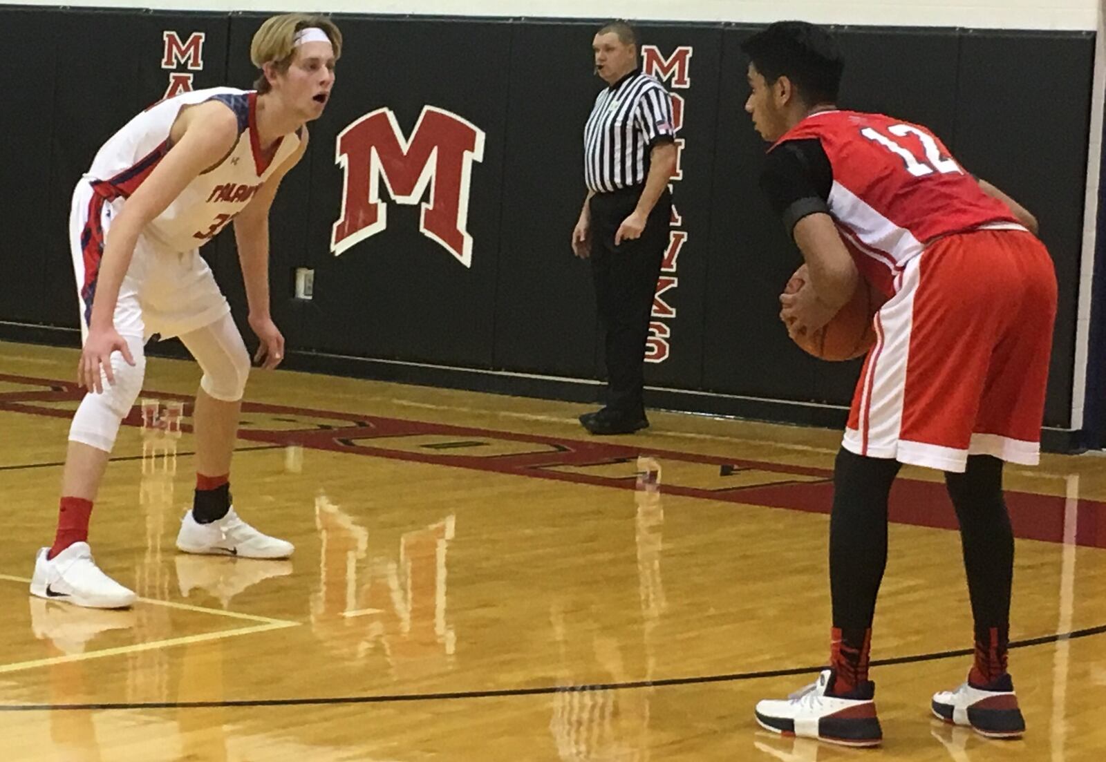 Talawanda’s Josh DeWitt (33) keeps a close eye on Miami Valley’s Kaelan Patel during Thursday night’s Brian Cook Classic at Madison. Talawanda advanced with a 51-48 victory. RICK CASSANO/STAFF