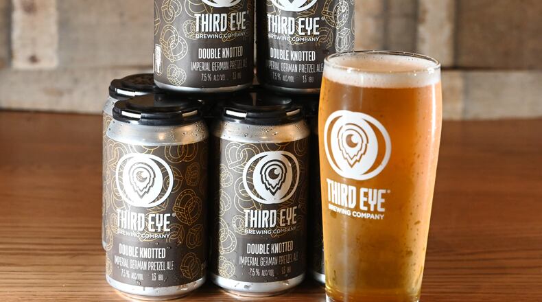Third Eye Brewing has created a limited edition Double Knotted Imperial German Pretzel Ale to celebrate National Pretzel Day, which a portion of the beer sales will support St. Vincent de Paul. Servatii is also participating in National Pretzel Day with Third Eye along with special deals at Servatii locations. The brewery produces normally Getting' Twisted, a German pretzel ale that's available year-round. Pictured is the Double Knotted Imperial German Pretzel Ale, which were canned on Tuesday, April 22, 2025, at the Third Eye Brewing Hamilton location. MICHAEL D. PITMAN/STAFF