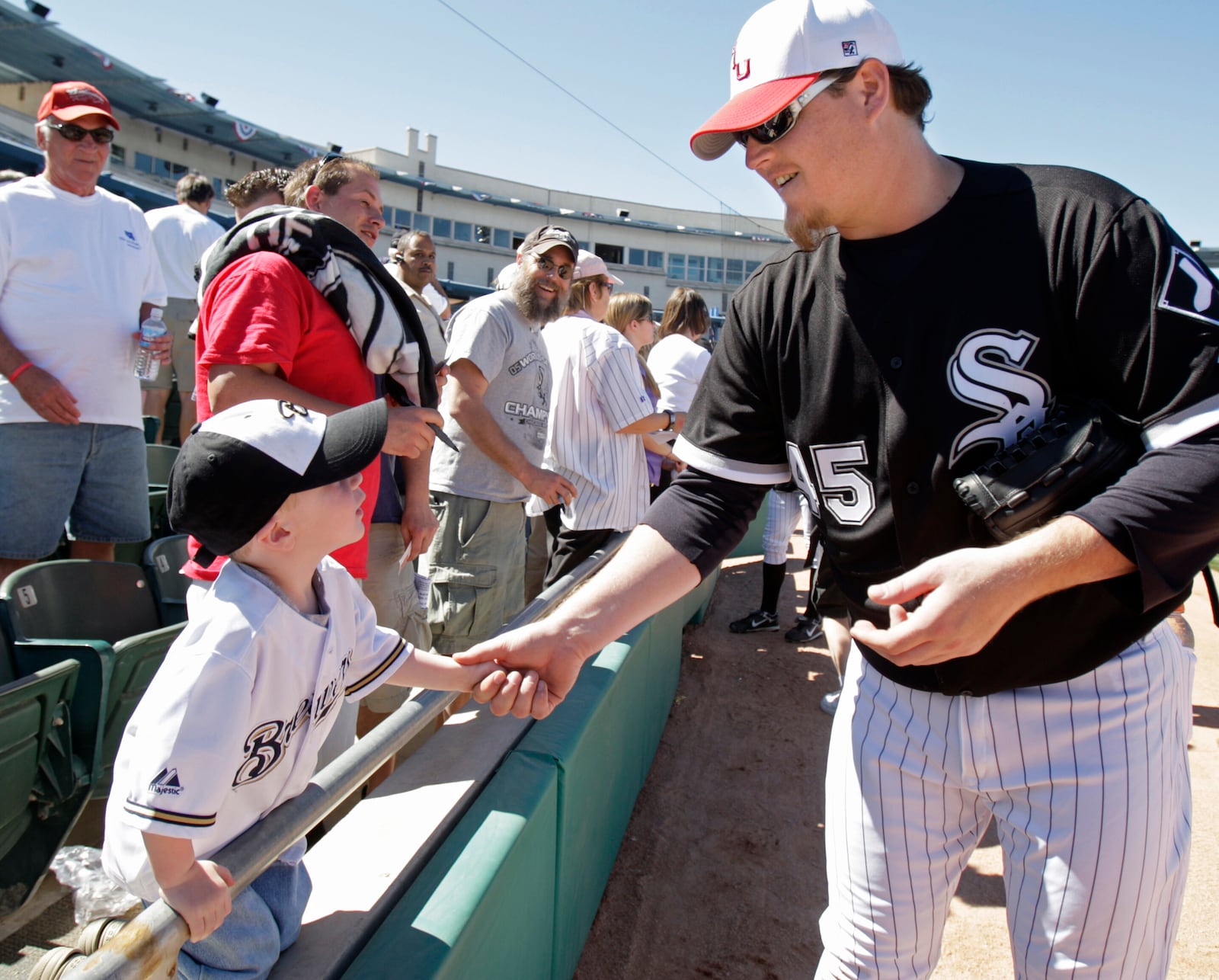 FILE - Chicago White Sox's Bobby Jenks shakes hands with 3-year-old Gherig Gesch before the White Sox's spring training baseball game against the Colorado Rockies on Feb. 27, 2008, in Tucson, Ariz. (AP Photo/M. Spencer Green, File)