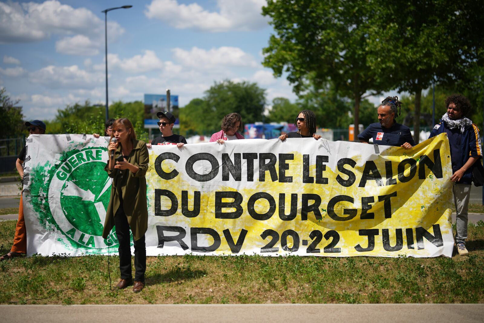 Activists stage a protest outside the Paris Airshow, Monday, June 16, 2025 in Le Bourget, outside Paris. (AP Photo/Thibault Camus)