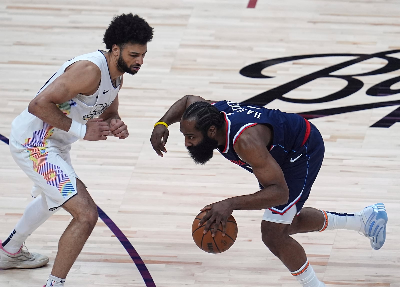 Los Angeles Clippers guard James Harden, right, collects a loose ball as Denver Nuggets guard Jamal Murray defends in the first half of Game 5 of an NBA basketball playoff series Tuesday, April 29, 2025, in Denver. (AP Photo/David Zalubowski)