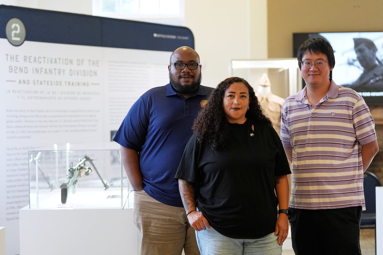 From left, Director of Exhibitions Cale Carter II, Director of Education Dr. Michelle Tovar, and archivist Jason Fung pose for a photo inside the Buffalo Soldiers National Museum on Friday, June 27, 2025, in Houston, Texas. (AP Photo/Ashley Landis)