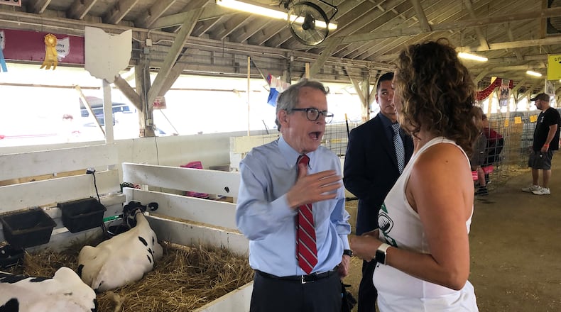 Governor Mike DeWine talks with Clark County Commissioner Melanie Flax-Wilt Monday, July 22, 2019, at the Clark County Fair. DeWine stopped by to see his granddaughter, who was showing her goat at the fair. BILL LACKEY / STAFF FILE