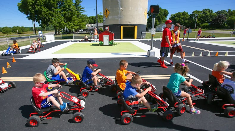 Children learn about road rules during Safety Town this week at Officer Bob Gentry Park in Hamilton. GREG LYNCH / STAFF