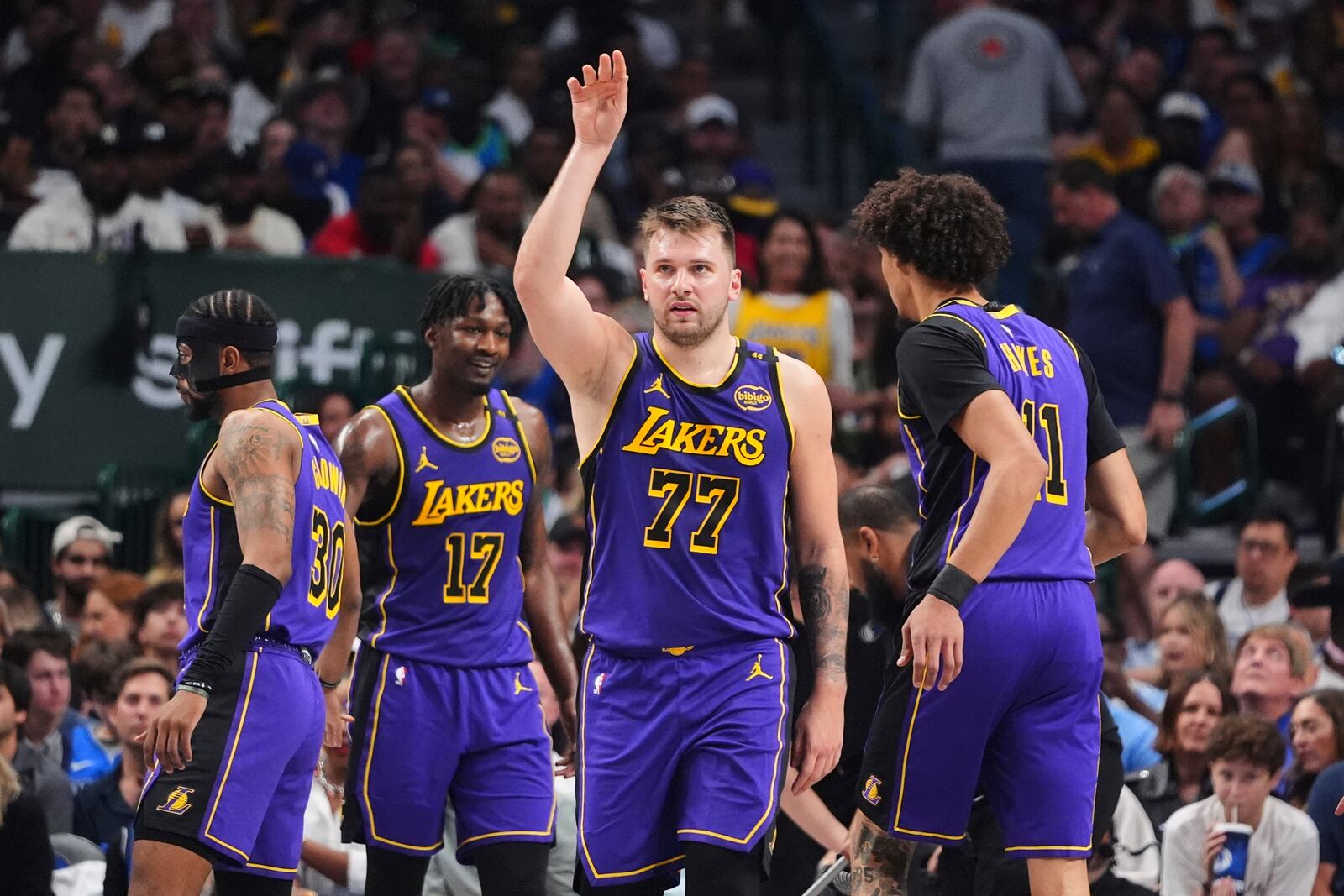 Los Angeles Lakers' Luka Doncic (77) gestures as he walks on the court during a time out in the first half of an NBA basketball game against the Dallas Mavericks in Dallas, Wednesday, April 9, 2025. (AP Photo/LM Otero)