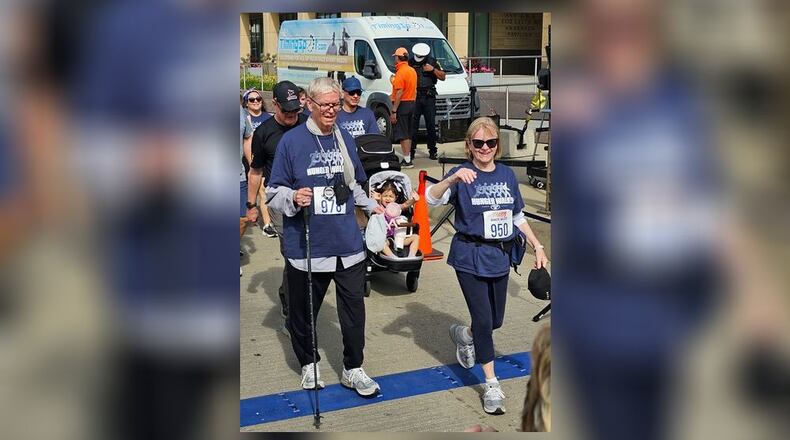 Dale Brown, 75, of Middletown, and his girlfriend, Ruth Blom, cross the finish line Monday of the 3.1-mile Hunger Walk in Cincinnati. SUBMIITTED PHOTO