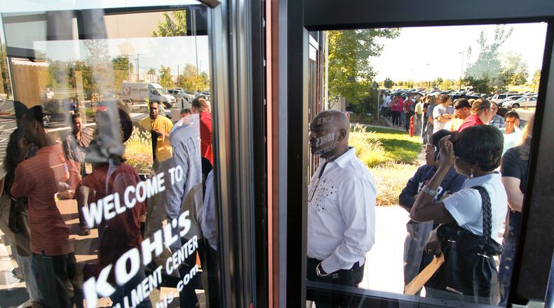 People wait in long lines Tuesday, September 11, 2012 in front of the Kohl’s distribution center in Monroe, Ohio to apply for one of the 1,200 seasonal jobs the company is offering. Staff photo by Gary Stelzer