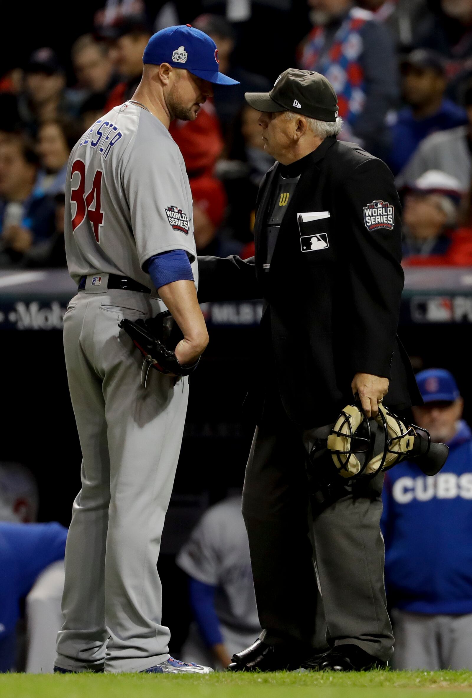 Chicago Cubs starting pitcher Jon Lester, left, talks to home plate umpire Larry Vanover after the third inning in Game 1 of the Major League Baseball World Series against the Cleveland Indians Tuesday, Oct. 25, 2016, in Cleveland. (AP Photo/Matt Slocum)