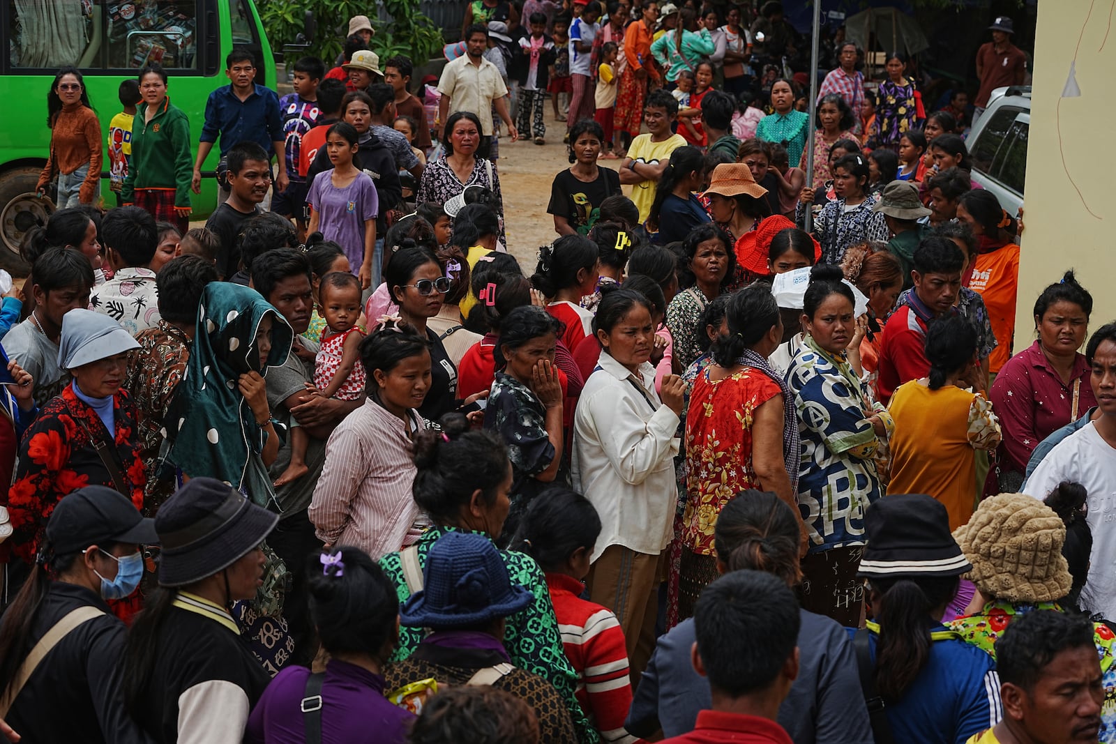 Local villagers wait to receive supplies donated by a charity, in Wat Phnom Kamboar, Oddar Meanchey province, Cambodia, Sunday, July 27, 2025, amid the fighting between Thailand and Cambodia. (AP Photo/Heng Sinith)