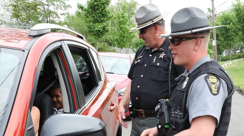 FILE: Clark County Sheriff’s Deputy Mark Lane and Sgt. Merrill Thompson of the Ohio State Highway Patrol check drivers to make sure they are wearing their seatbelts as they leaving Catholic Central High School. The safety check kicked off their Click It Or Ticket campaign that runs through June 4. Bill Lackey/Staff