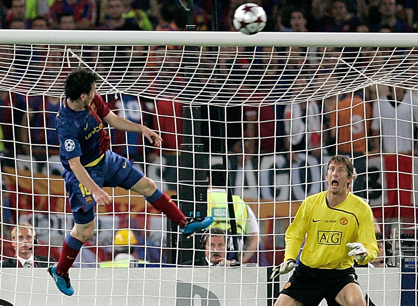 FILE - Barcelona's Lionel Messi, left, scores on a header during the UEFA Champions League final soccer match between Manchester United and Barcelona in Rome, May 27, 2009. Barcelona won 2-0. (AP Photo/Gregorio Borgia, File)