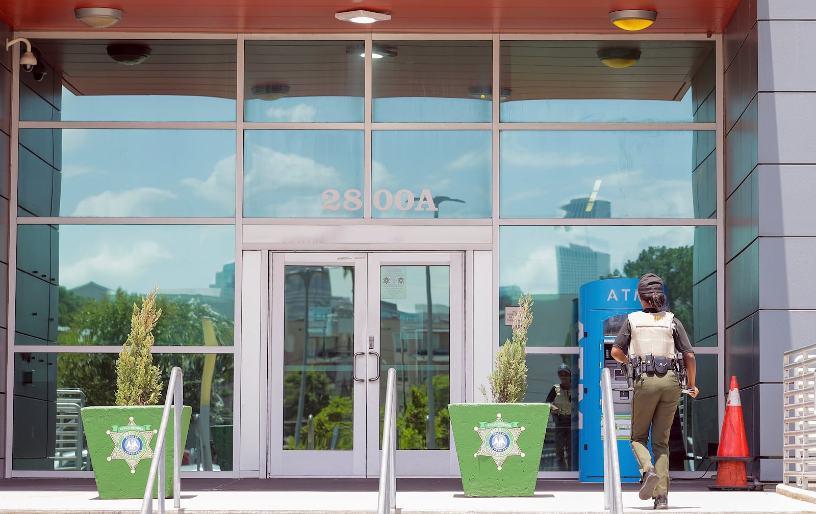 A law enforcement officer enters the Orleans Parish Sheriff's Office in New Orleans on Friday, May 16, 2025. (Brett Duke /The Advocate via AP)