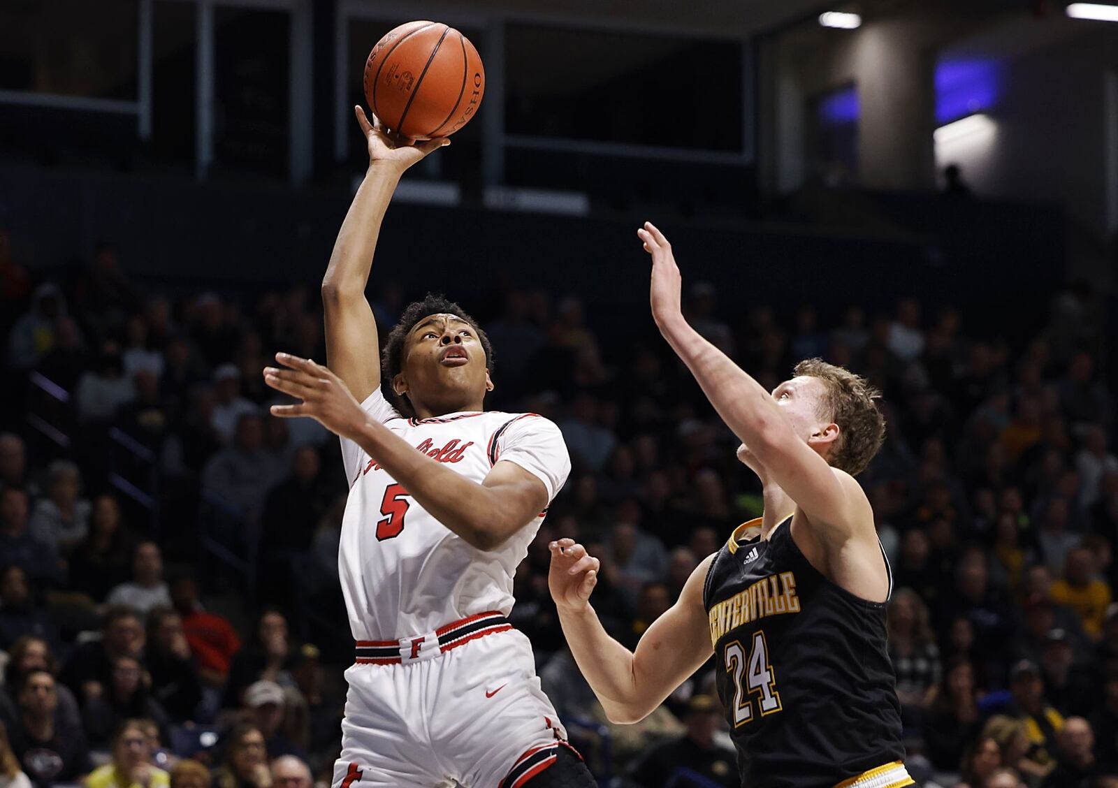 Fairfield's Owen Bronston goes to the hoop over Centerville's Richard Rolf during their Division I regional basketball final Saturday, March 12, 2022 at Xavier University's Cintas Center in Cincinnati. Centerville won 55-39. NICK GRAHAM/STAFF