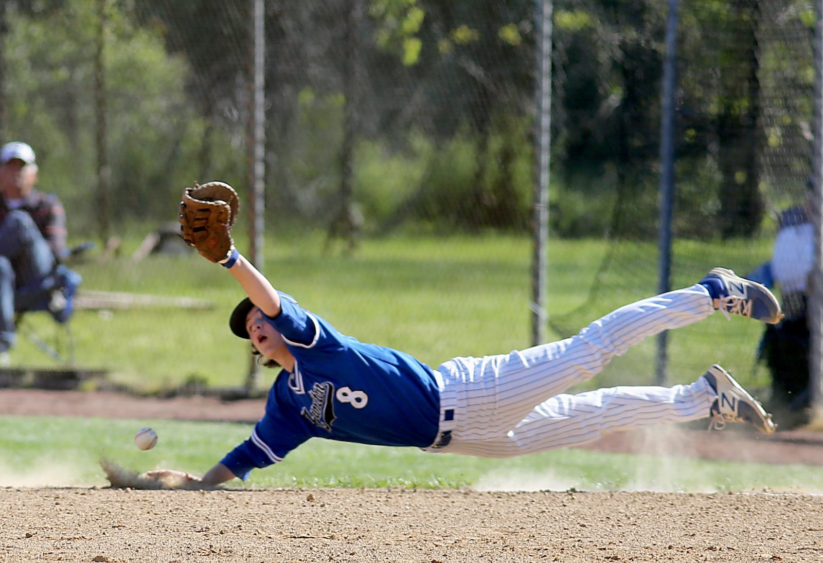 Hamilton first baseman Alex Mills can’t get a grip on the ball during Sunday’s game against Fairfield at Joe Nuxhall Field in Fairfield. CONTRIBUTED PHOTO BY E.L. HUBBARD