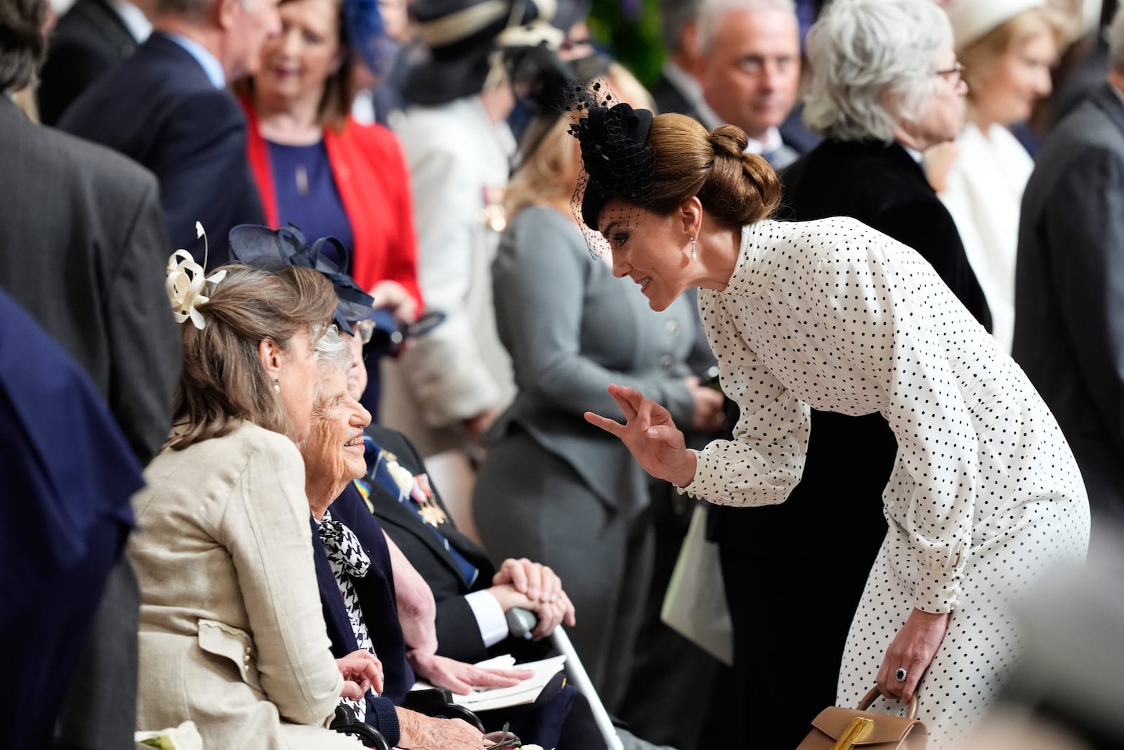 Kate, Princess of Wales, speaks to a veteran during a Service of Thanksgiving at Westminster Abbey on V-E Day in London, Thursday, May 8, 2025. (Jordan Pettitt/Pool Photo via AP)