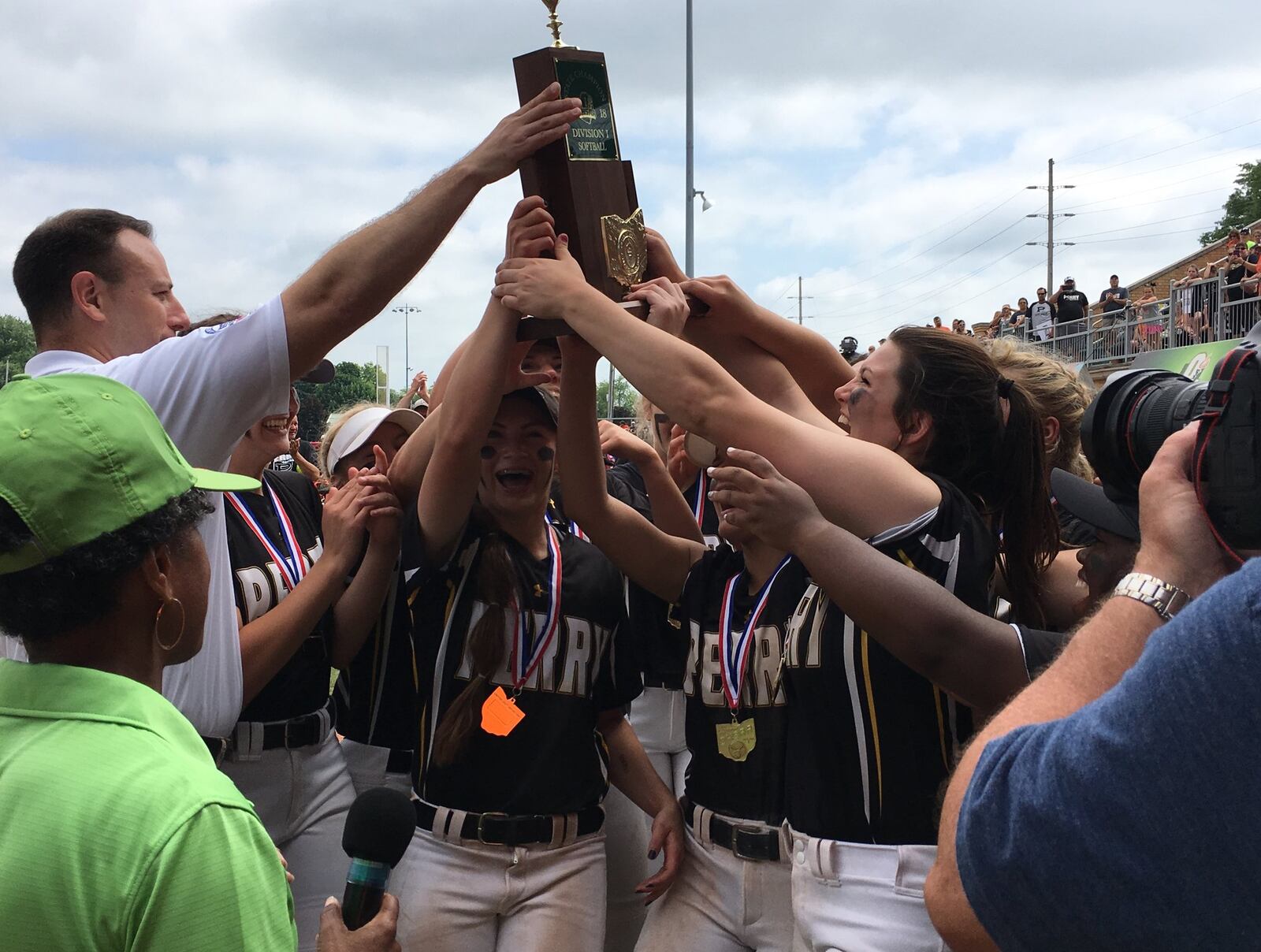 The Massillon Perry Panthers accept the Division I state championship trophy from the Ohio High School Athletic Association’s Tim Stried after defeating Lakota West 11-1 on Saturday afternoon at Firestone Stadium in Akron. RICK CASSANO/STAFF