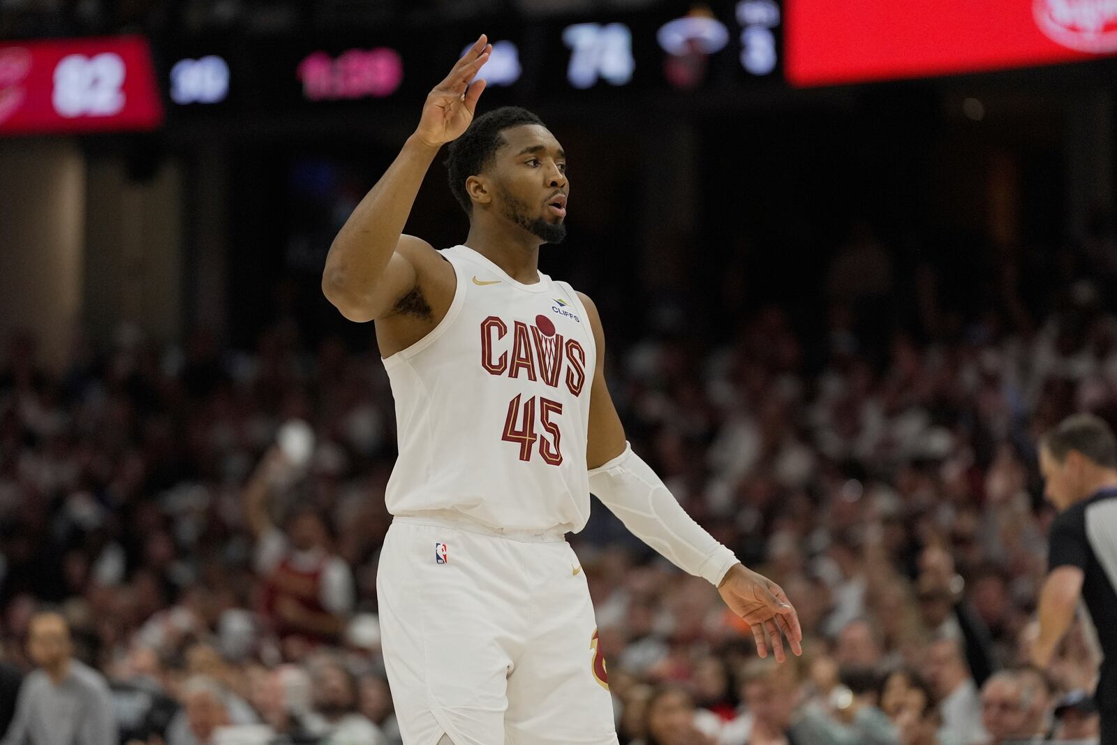 Cleveland Cavaliers guard Donovan Mitchell (45) gestures after hitting a three-point basket in the second half in Game 1 of an NBA first-round playoff series against the Miami Heat, Sunday, April 20, 2025, in Cleveland. (AP Photo/Sue Ogrocki)