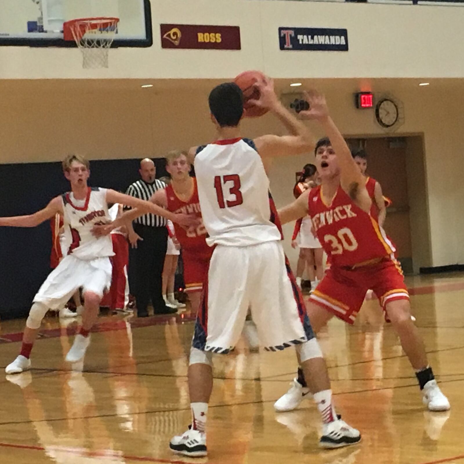 Talawanda’s Tommy Winkler (13) is defended by Fenwick’s John Engelmeier (30) during Friday night’s game in Oxford. Down low, the battle is between Talawanda’s Josh DeWitt (33) and Fenwick’s C.J. Napier (22). The visiting Falcons won 64-40. RICK CASSANO/STAFF