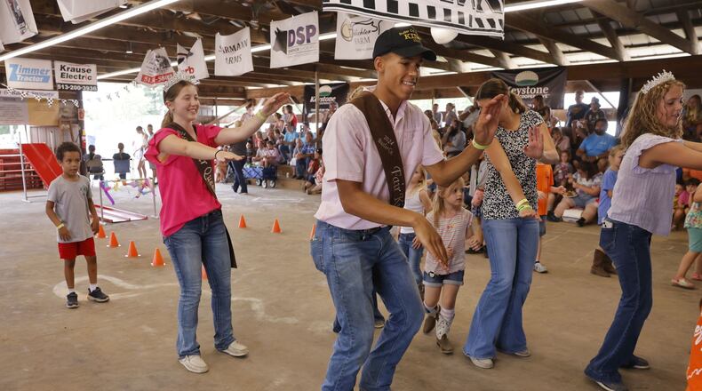 Butler County Fair Queen Emma Puckett, left, and King Brayden Kidd lead line dancing with kids Wednesday, July 24, 2024 at Butler County Fair in Hamilton. NICK GRAHAM/STAFF