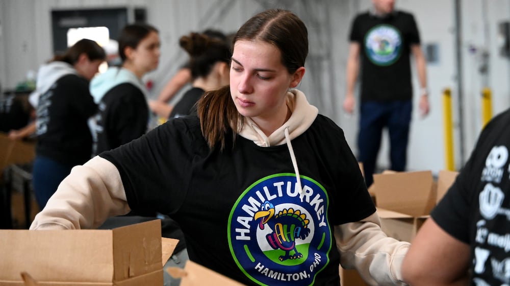 Shared Harvest saw about 30 volunteers from multiple organizations pack boxes on Friday, Nov. 14, 2025, for the annual Hamil-Turkey event, where thousands of people will be fed through these prepackaged Thanksgiving dinners. Hundreds of more people are expected to be fed at a Thanksgiving buffet dinner sponsored by various organizations. MICHAEL D. PITMAN/STAFF