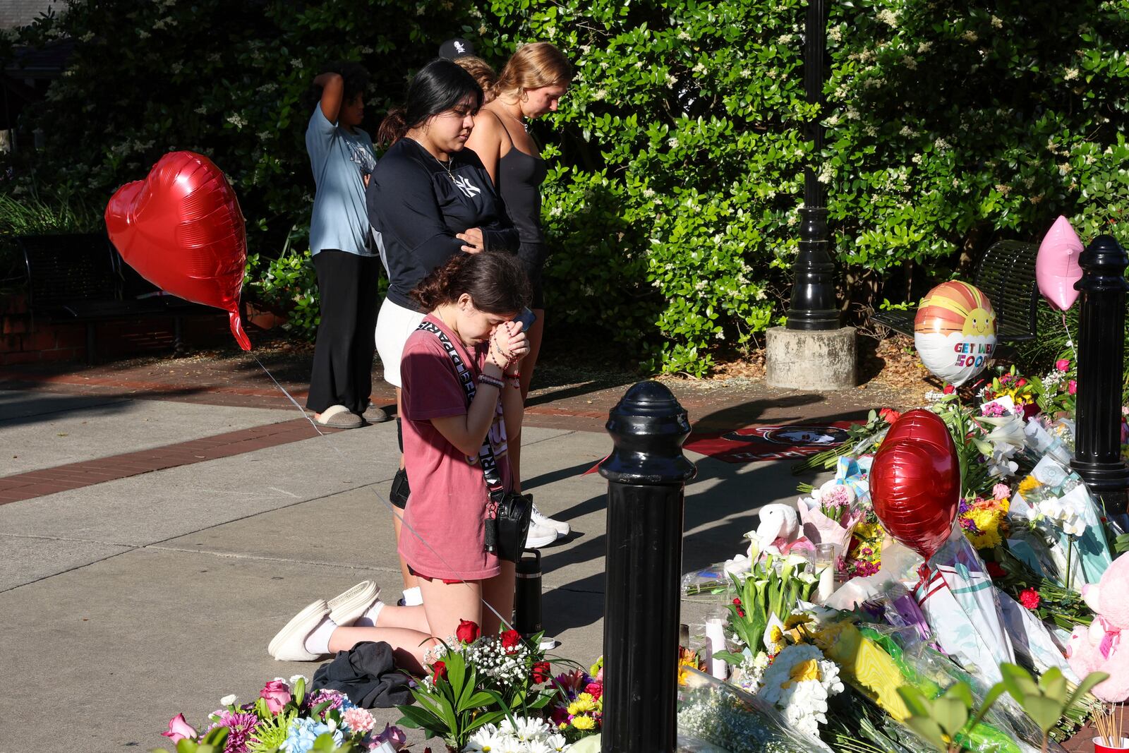 Students gather on a stretch of sidewalk near the center of the Florida State campus in sight of the Student Union building, Tallahassee, Fla., Friday, April 18, 2025. (AP Photo/Gary McCullough)