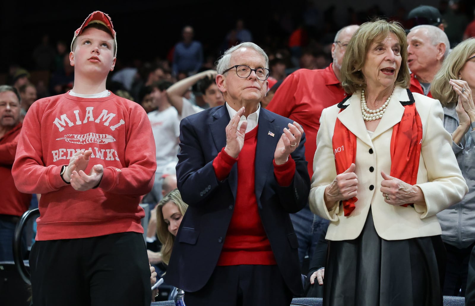 Gov. Mike DeWine (right) and First Lady Fran DeWine (left) cheer as Miami University players run onto the floor for pregame warmups before an NCAA First Four game against Southern Methodist University on Wednesday, March 18 at University of Dayton Arena. BRYANT BILLING / STAFF