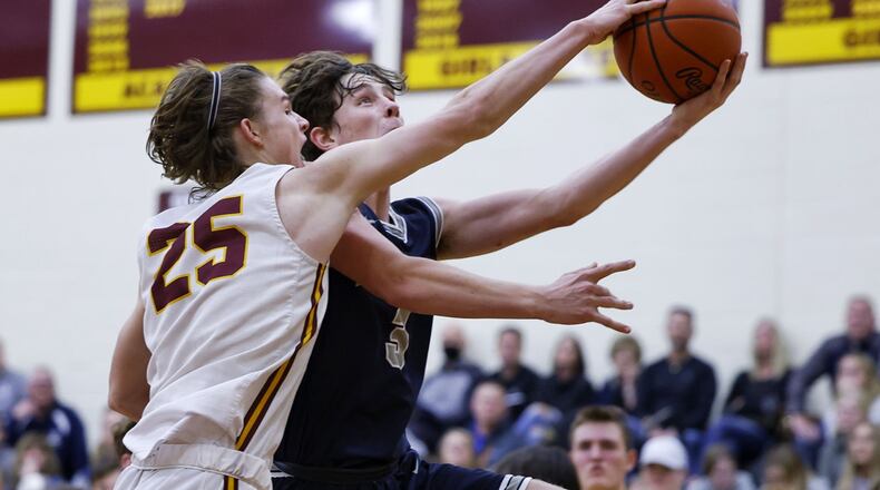 Edgewood guard Peyton Smith goes to the basket defended by Ross forward Jeff Valentine during their basketball game Friday, Jan. 7, 2022 at Ross High School. Edgewood won 61-56 in overtime. NICK GRAHAM / STAFF
