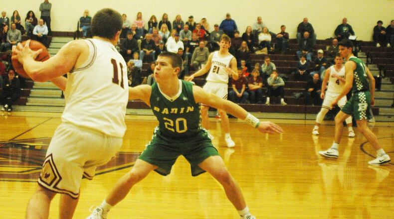 Badin’s Alex DeLong (20) comes after Columbus Watterson’s Matt Rhomberg (11) during Wednesday night’s game in Columbus. Badin won 58-49. RICK CASSANO/STAFF