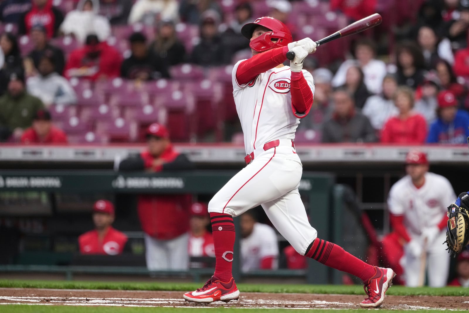 Cincinnati Reds' Matt McLain hits a two-run home run in the first inning of a baseball game against the Texas Rangers, Monday, March 31, 2025, in Cincinnati. (AP Photo/Kareem Elgazzar)