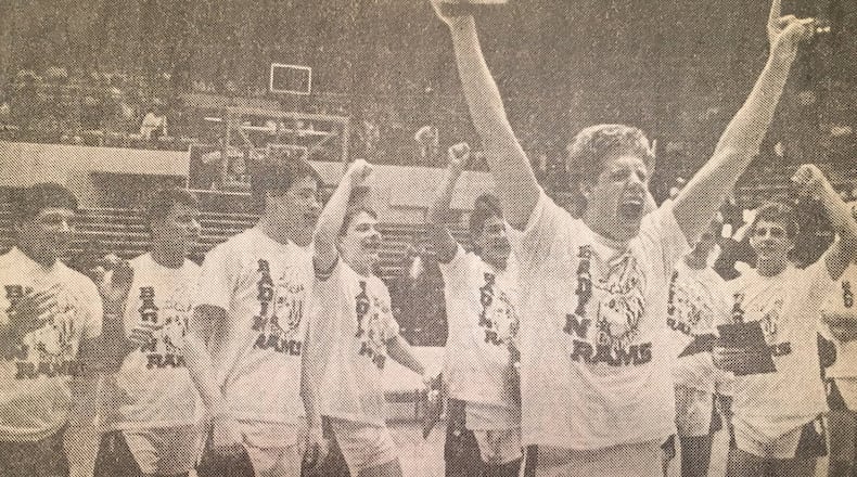 Badin’s Jon Webster (front) celebrates with his teammates after the Rams defeated Zoarville Tuscarawas Valley 68-63 to win the Division III state championship March 26, 1988, at St. John Arena in Columbus. COX MEDIA FILE PHOTO