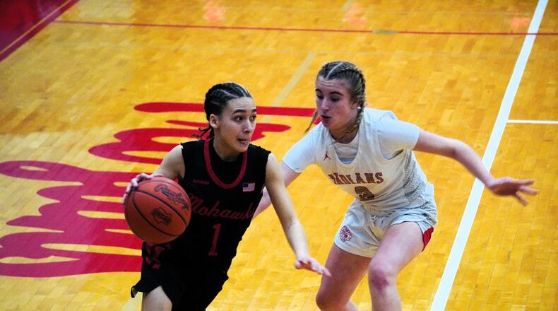 Madison's Malerie Bobbitt (1) is guarded by Carlisle's Allisa Shotwell (3) during a Division IV tournament game on Tuesday at Troy. Chris Vogt/CONTRIBUTED