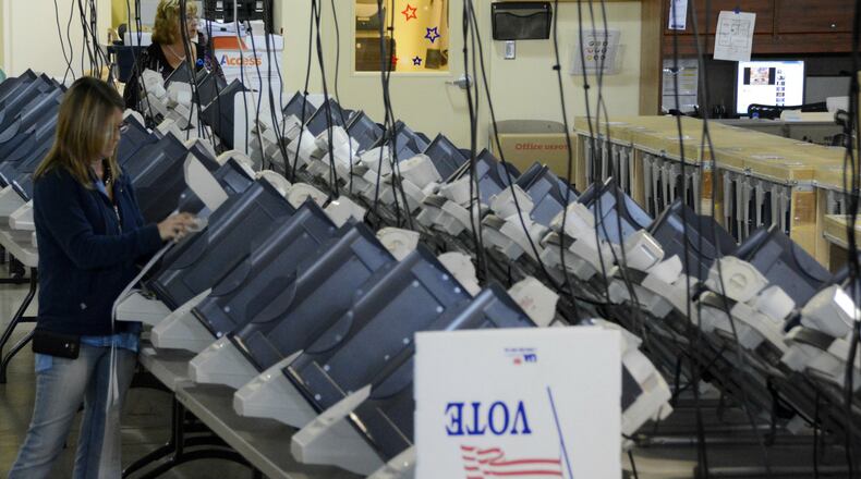 The state of Ohio is making $114 million available for county boards of elections to purchase new voting machines. Butler County is one of the many counties who are operating on equipment purchased in 2005 but have operating systems older than that, according to election officials. Pictured Melisa Kuemmerling in September 2016 testing machines voters use on Election Day. MICHAEL D. PITMAN/FILE