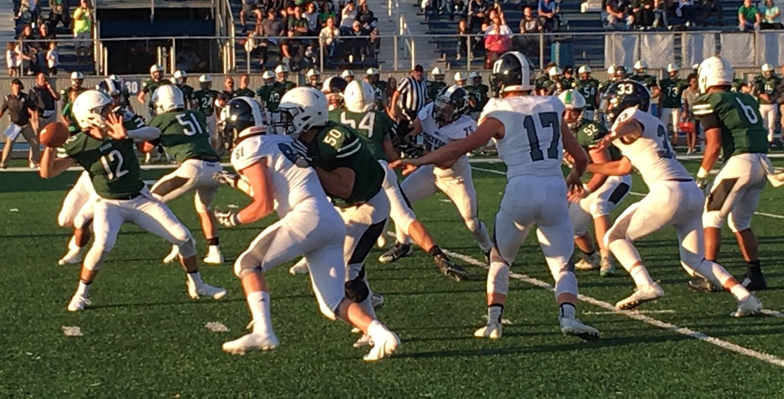 Badin quarterback Jordan Flaig (12) prepares to launch a pass during Saturday night’s game against Edgewood at Virgil Schwarm Stadium in Hamilton. RICK CASSANO/STAFF
