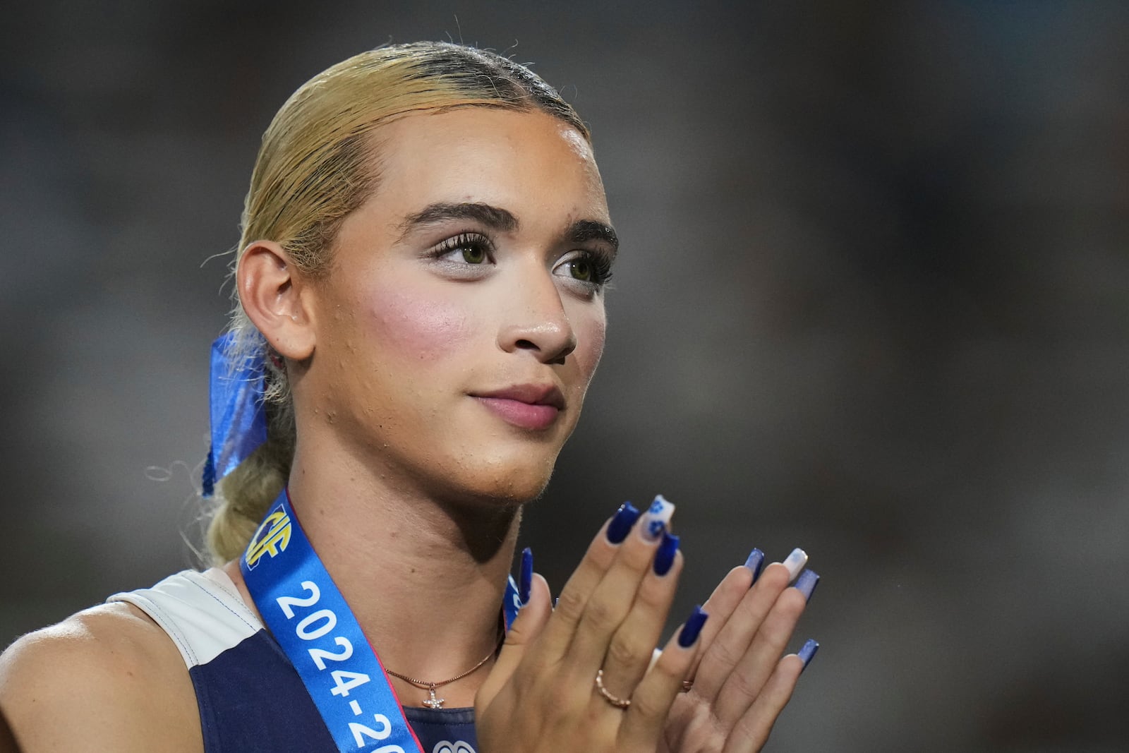 FILE - AB Hernandez, a transgender student at Jurupa Valley High School, stands on the podium during a medal ceremony for the triple jump at the California high school track-and-field championships in Clovis, Calif., May 31, 2025. (AP Photo/Jae C. Hong, file)